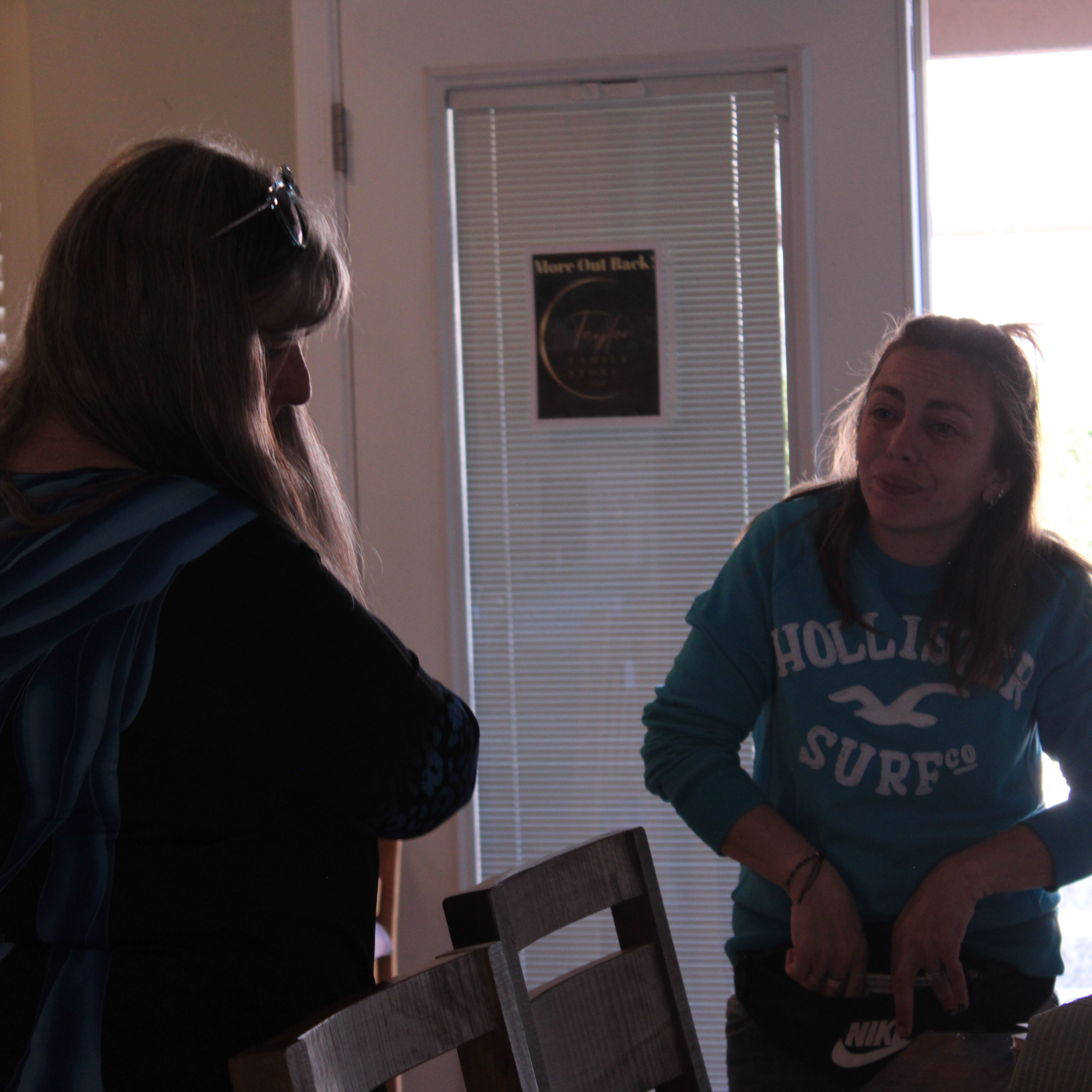 Estate sale shoppers examining items at Kingman liquidation event